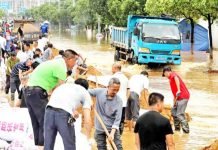 China battles record flood by heavy rain; dozens reported dead, 433 rivers burst banks