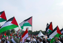 The World Unites Against U.S.-Israeli Brutality in Gaza Protesters with Palestinian flags demand Gaza ceasefire