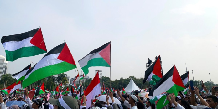 Global Protest Against U.S.-Israeli Brutality Protesters with Palestinian flags demand Gaza ceasefire